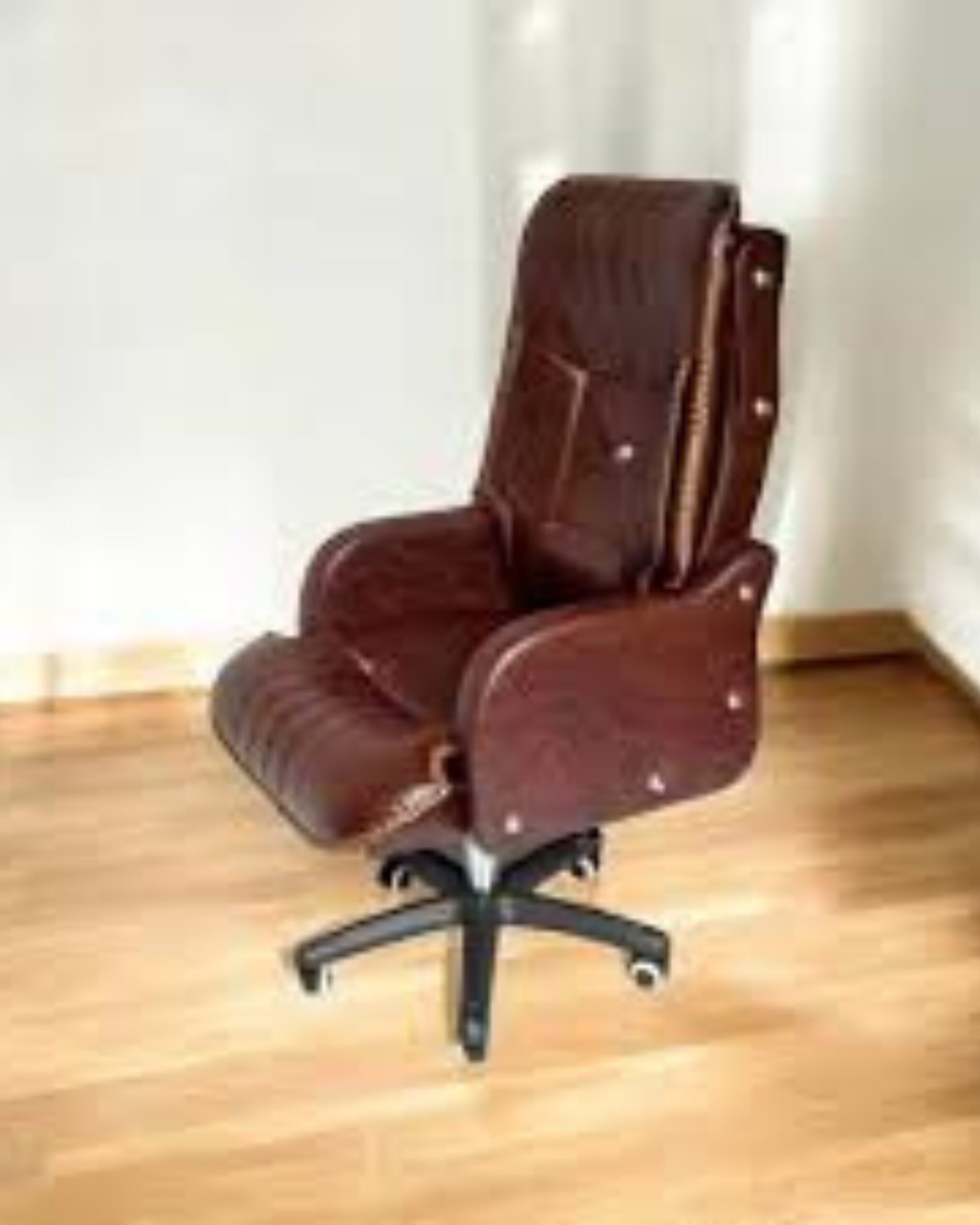 high back leather executive boss chair showing padded armrests and base